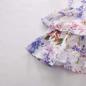 Macro view of delicate purple floral print and ruffled hem on sweet style summer dress