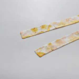 Close-up detail of yellow and pink floral print fabric waist ties for pastoral style dress