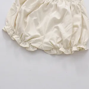 Close-up detail of cream ruffled bloomer shorts with soft elastic waist