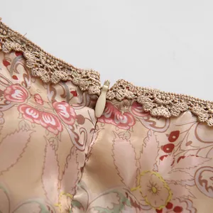 Detailed macro view of high-quality invisible zipper and beige lace trim on a vintage floral dress