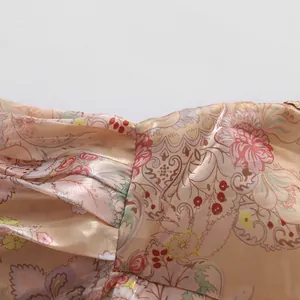 Detailed close-up view of vintage floral print fabric with elegant pleats and lace trim