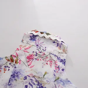 Close-up detail of wavy scalloped edge and floral print on sleeveless dress