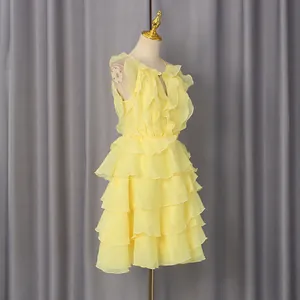 Detailed view of yellow ruffle sleeveless mini dress with layered high waist design