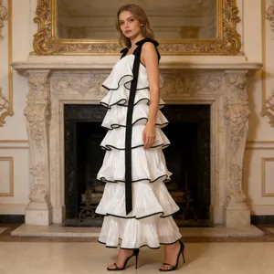 Elegant sleeveless white tiered maxi cake dress with decorative black ribbon straps