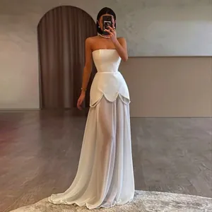 Detail view of elegant white strapless mesh evening dress with pearl beading