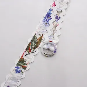 Close-up of floral fabric waist belt with white scalloped edges and round buckle
