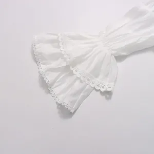 Détail de manche cloche blanche avec broderie délicate sur une robe de style français