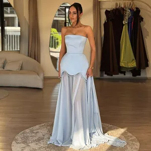 Detail view of elegant light blue strapless dress with pearl beads and mesh layers.