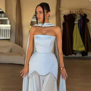 Elegant light blue strapless evening dress featuring pearl beadwork and sheer mesh accents.