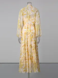 Romantic yellow floral lantern sleeve maxi dress with tie-waist shown from the back