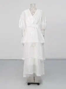 Elegant white vintage V-neck tiered long dress with lace trim and puff sleeves detail