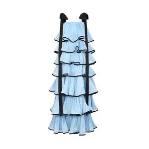 Light blue tiered ruffle maxi dress with black bow shoulder straps and contrast trim details.