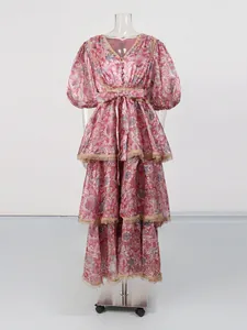 Vintage floral print V-neck maxi dress with lace trim and tiered skirt on mannequin
