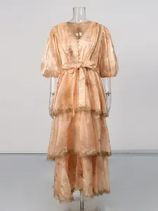 Elegant vintage peach V-neck maxi dress featuring intricate lace trim and bow-tie waist detail