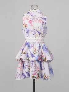 Floral sleeveless tiered mini dress featuring a wave-edge waist design, shown from back.