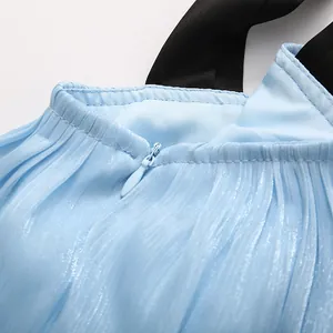 Close-up of light blue pleated tiered dress with invisible zipper and black straps.