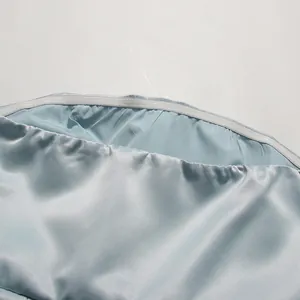 Close-up detail of the anti-slip silicone strip inside a light blue satin bandeau dress.
