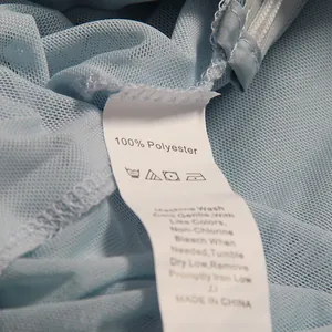 Macro detail showing the texture of light blue mesh fabric and the washing care label