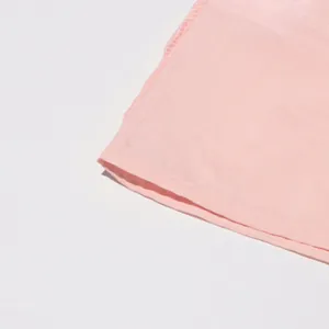 Close-up detail of the hemline and stitching on a pink French style dress