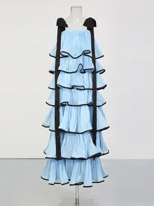 Light blue tiered cake dress with black ribbon straps and piping details