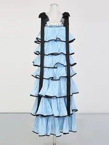 Elegant light blue tiered maxi dress with black ribbon straps and ruffled details