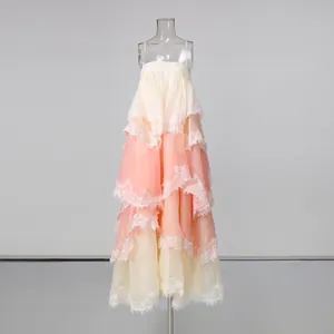 Front view of a romantic layered lace camisole maxi dress with peach gradient tiers.