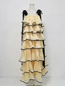 Elegant long tiered ruffle cake dress with black ribbon straps and metallic sheen