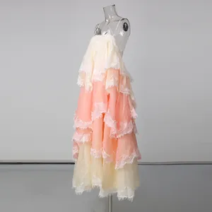 Close-up detail of the layered peach and cream lace patchwork tiered maxi holiday dress