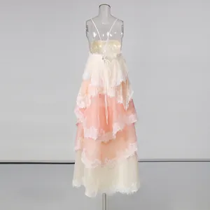 Detailed back view of a tiered lace maxi dress with romantic coral gradient layers