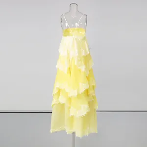 Back view detail of yellow tiered maxi dress with delicate lace patchwork design