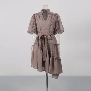Detail showing the V-neck lace patchwork and puff sleeve of a tea-break style dress.