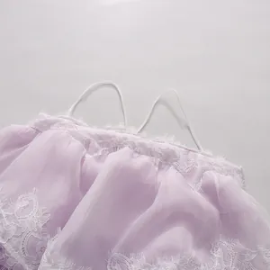 Close-up detail showing the delicate white lace trim and straps of a romantic purple tiered dress