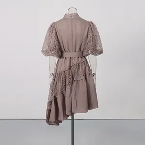 Back view of mauve puff sleeve dress with lace details and asymmetrical hemline.