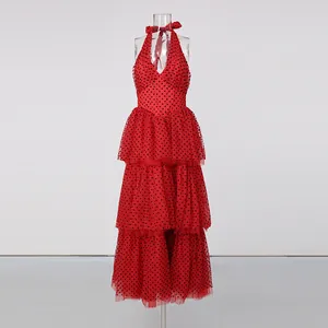 Close-up detail of the red polka dot tiered mesh skirt on this romantic halter dress