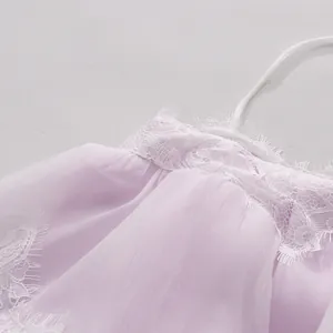Close-up of lavender tiered dress with exquisite white lace trim and pleats