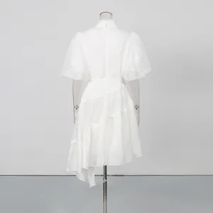 Detailed back view of a white lace puff sleeve dress with an asymmetrical hemline