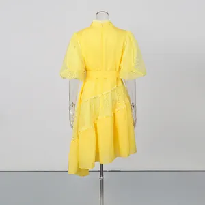 Elegant yellow tea break dress featuring puff sleeves and an asymmetrical lace hem design.