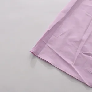 Close-up detail of the clean stitched hem on this light purple romantic vacation dress