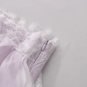 Detailed close-up of lavender lace trim and a concealed zipper on a feminine summer dress