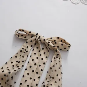 Detailed view of the mesh polka dot bow decoration on a retro romantic evening dress