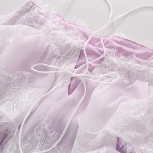Exquisite close-up of lace patchwork and back lacing detail on romantic lavender chiffon dress