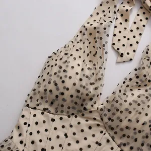 Detailed view of a vintage halter neck polka dot party dress featuring layered mesh fabric
