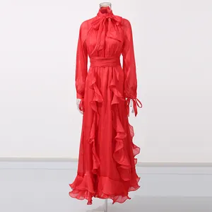 Elegantes rotes Langarmkleid mit Rüschensaum und zarter Schleife am Ausschnitt.