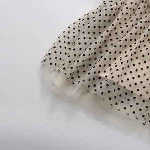 Close-up of retro polka dot pattern on layered mesh tulle fabric for an evening dress