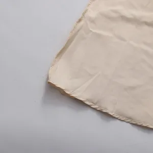 Macro view showing the high-quality hemline stitching on this beige vintage banquet dress
