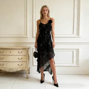 Elegant black ruffled spaghetti strap dress featuring asymmetrical hem and floral shoulder detail