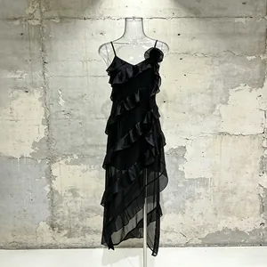 Elegant black sleeveless midi dress with cascading ruffles and floral accent detail