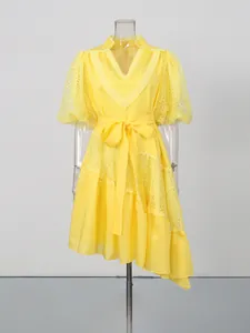 Elegant yellow V-neck tea dress featuring lace puff sleeves and asymmetrical hem design