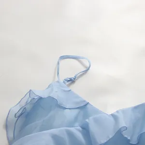 Close-up detail of light blue ruffled dress with thin adjustable spaghetti strap.
