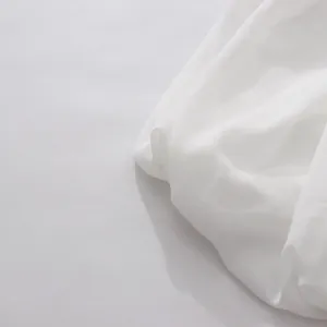 Detalle de tela de gasa blanca semitransparente con una caída suave y elegante